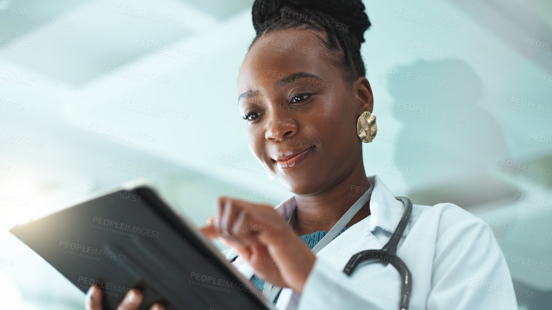 Buy stock photo Black woman, doctor and satisfied with tablet at hospital for medical records, report and data. Female person, employee and smile or happy at clinic on website for telehealth, healthcare and schedule