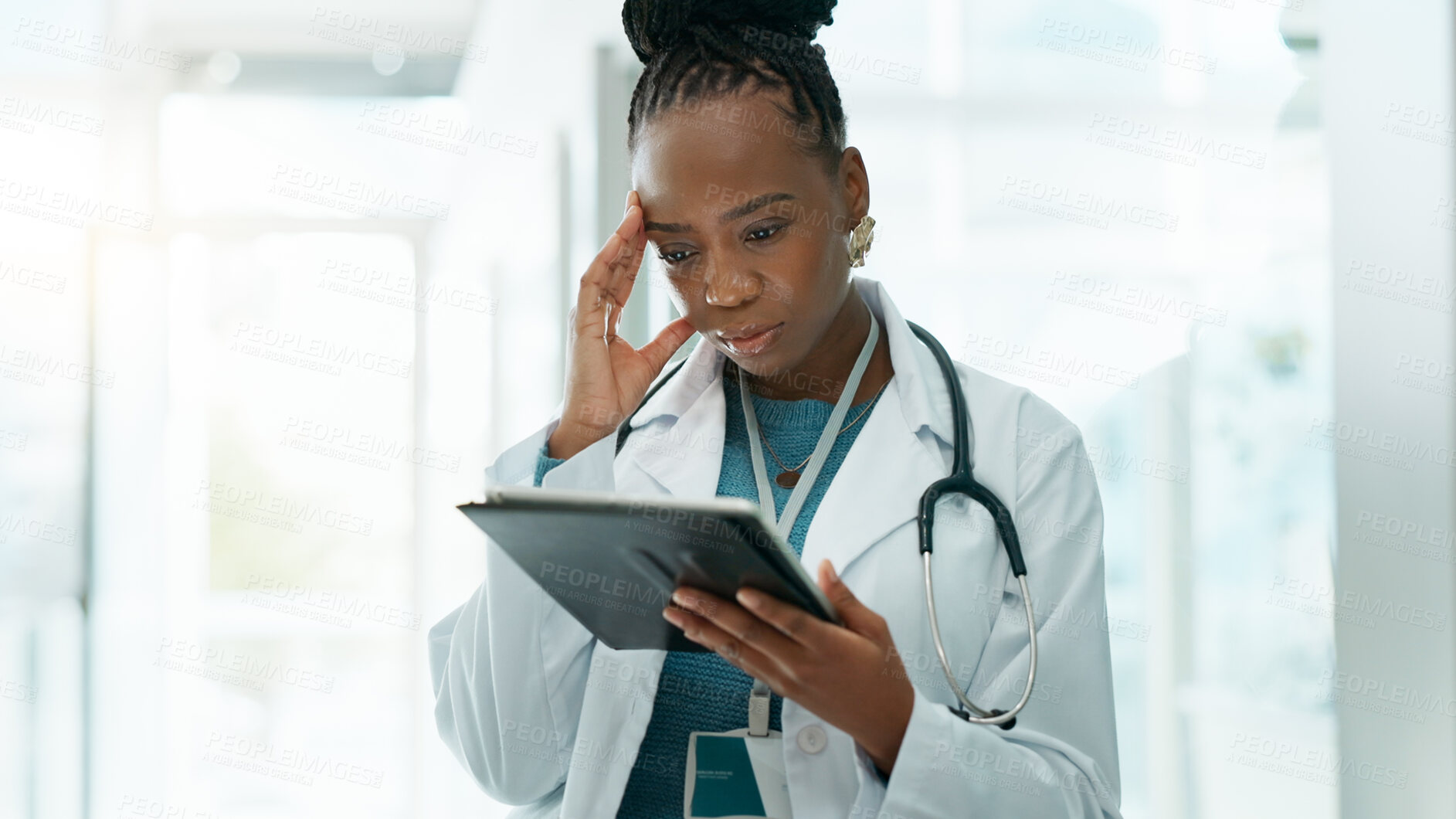 Buy stock photo Black woman, doctor and worried with tablet at hospital on internet for busy schedule and appointment. Female person, employee and stress at clinic for telehealth with bad reviews or patient feedback