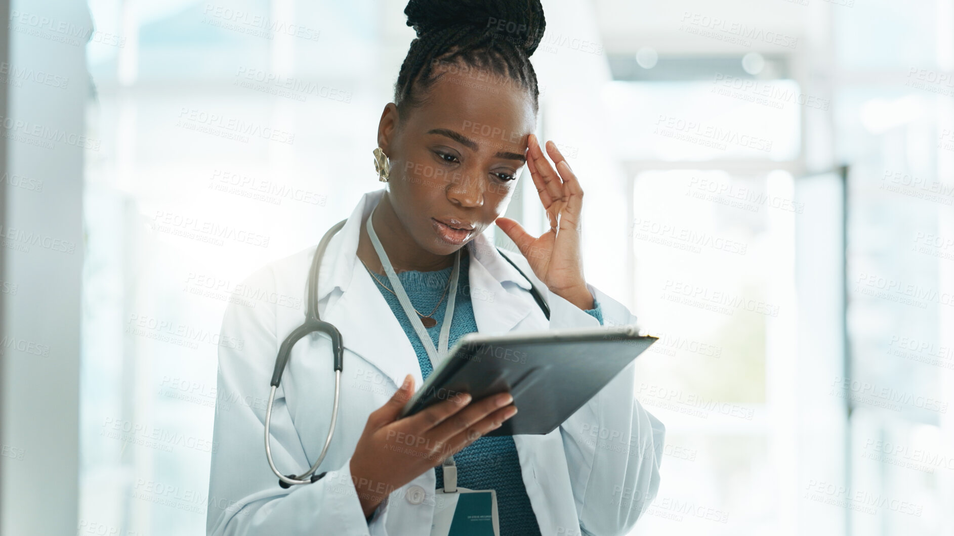 Buy stock photo Black woman, doctor and stress with tablet at hospital on internet for busy schedule and appointment. Female person, employee and worried at clinic for telehealth with bad reviews or patient feedback