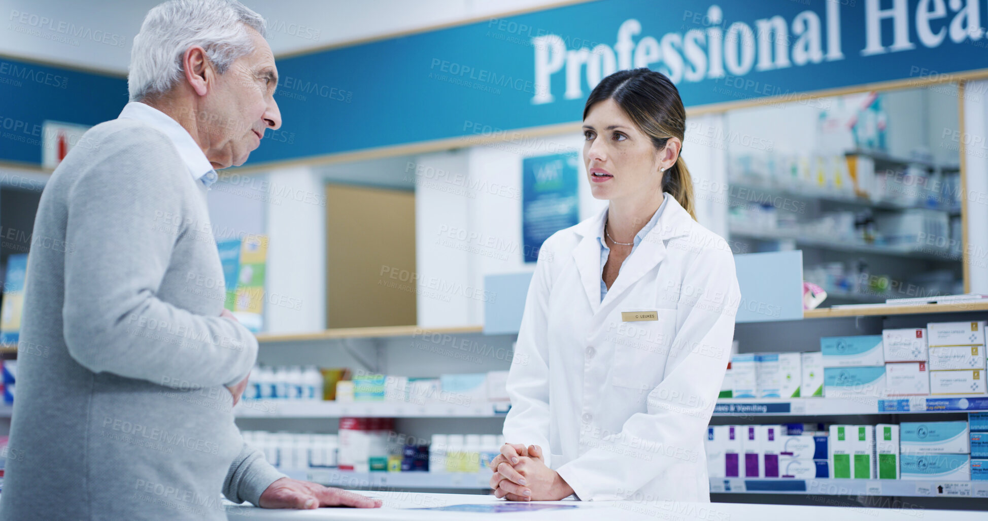 Buy stock photo Pharmacist, medicine and consultation with senior customer for stomach problem, advice or pain in retail store. Medical pharmacy, woman and talk to man with diarrhea, constipation or gut healthcare