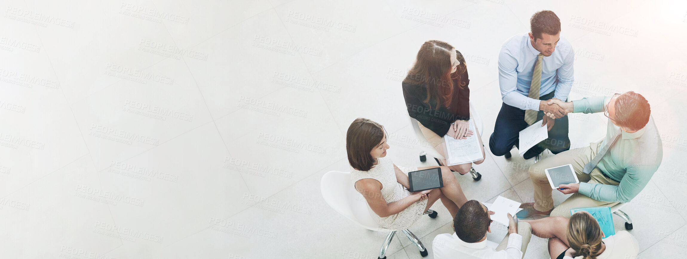 Buy stock photo High angle shot of a group of businesspeople meeting in the office