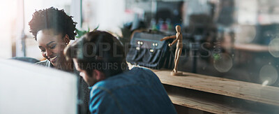 Buy stock photo Shot of two young businesspeople talking in the office