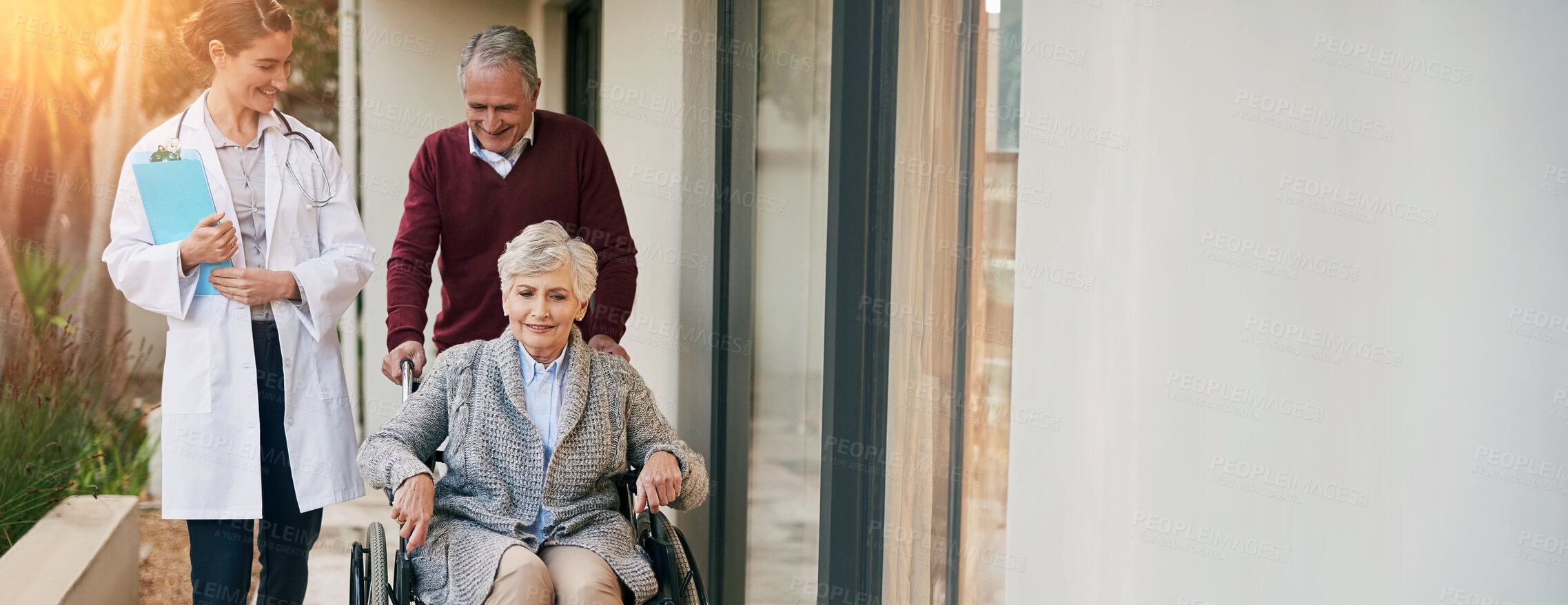 Buy stock photo Shot of a senior couple and a nurse outside a nursing home