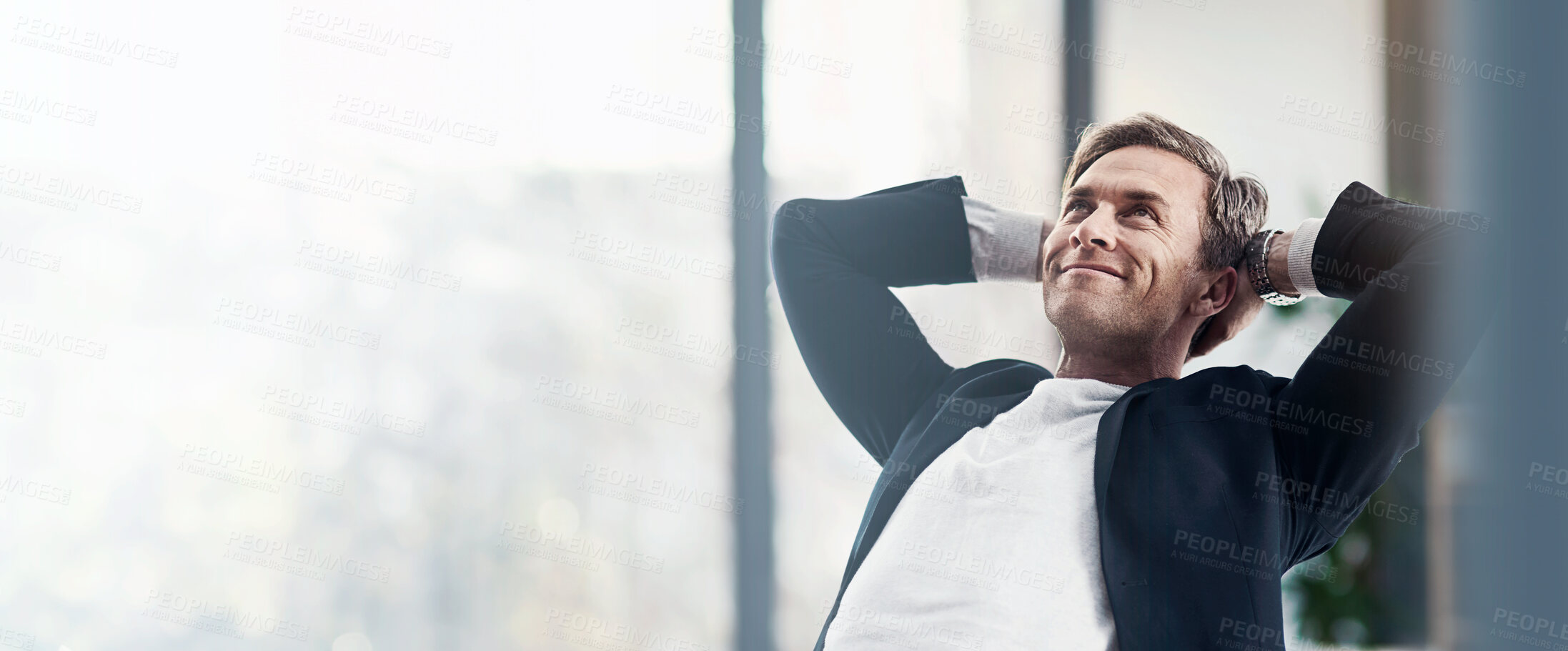 Buy stock photo Shot of a happy businessman leaning back in his chair