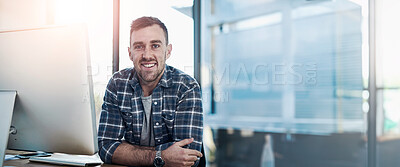 Buy stock photo Portrait of a happy young businessman working at his office desk