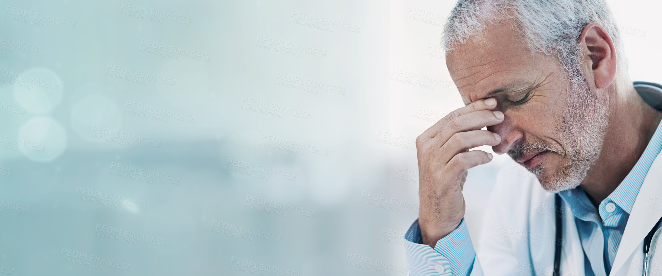 Buy stock photo Cropped shot of a mature doctor feeling stressed out at work