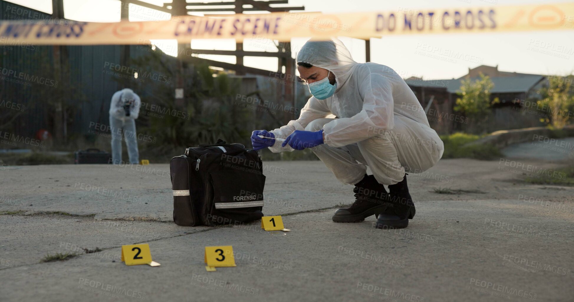 Buy stock photo Person, forensic and sample of crime scene with evidence outdoor, dna investigation and murder inspection. Team, hazmat and police tape for blood review, swab observation and documentation protocol 