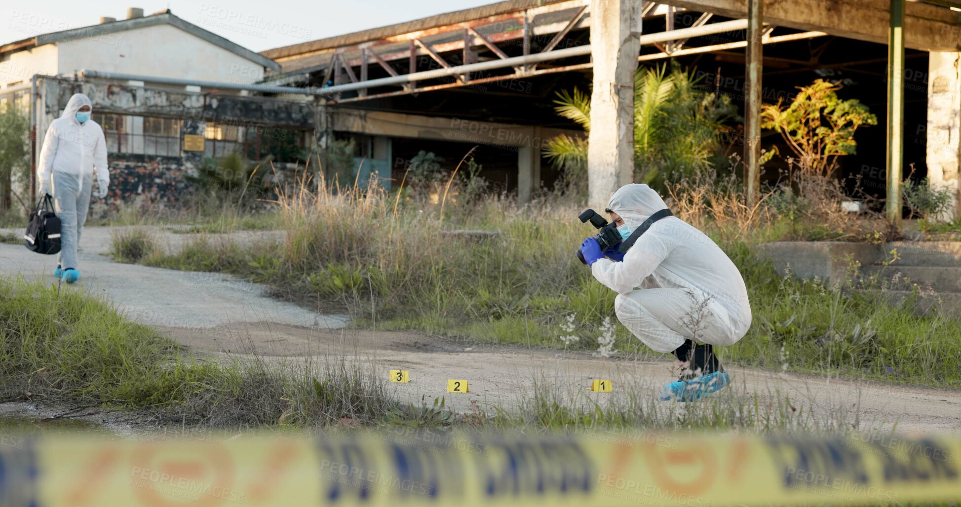 Buy stock photo Crime scene, people and photography outdoor for forensics, evidence and investigation. CSI team, hazmat suit and camera in field for inspection, observation and documenting proof at police markers