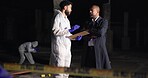 Forensics team, men and discussion at crime scene for investigation with clipboard, report or evidence at night. Investigators, detective and police outdoor for murder case, talk or clues for mystery