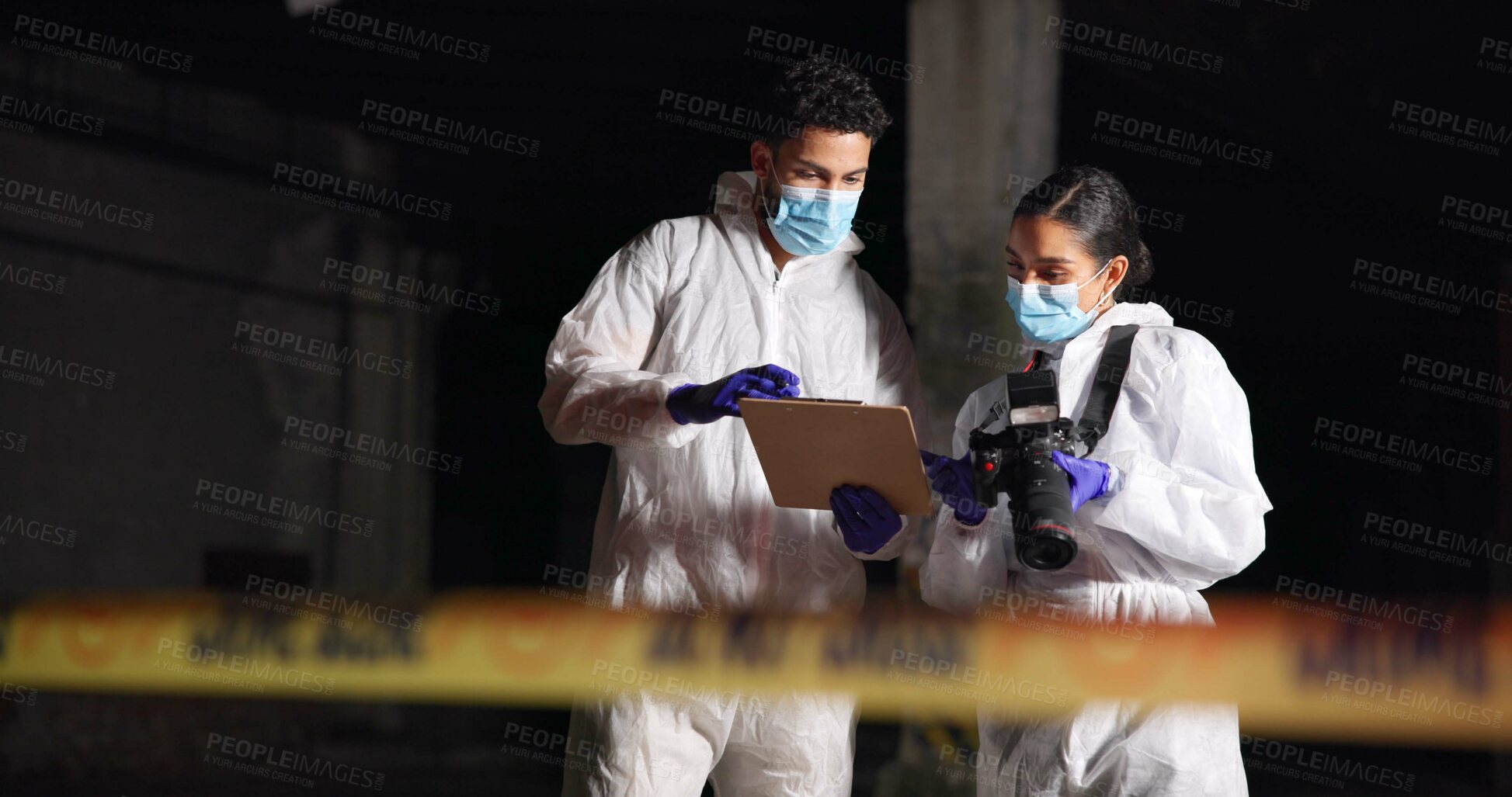 Buy stock photo Forensics team, report and crime scene investigation with clipboard, talking or show evidence at night. Investigators, man and woman with police outdoor for murder case, planning or clues for mystery