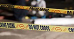 Crime scene, police tape and accident in building for investigation with safety warning, danger and evidence. CSI inspection, closeup sign and do not cross in abandoned garage for emergency or murder