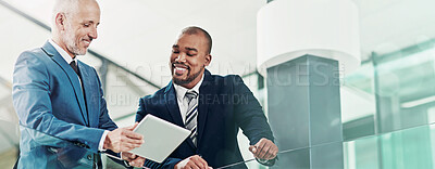 Buy stock photo Cropped shot of a businessman showing something to his colleague on his tablet in the office