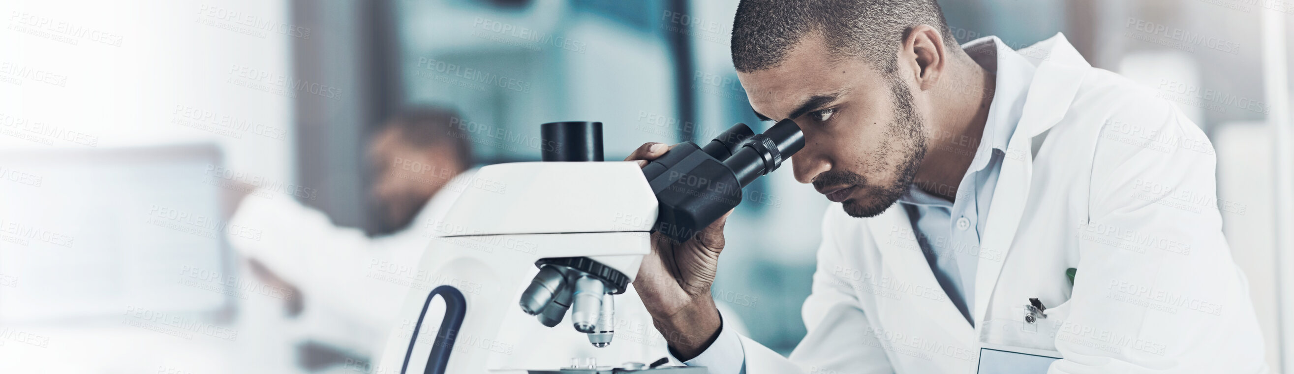 Buy stock photo Cropped shot of a young male scientist working in his lab