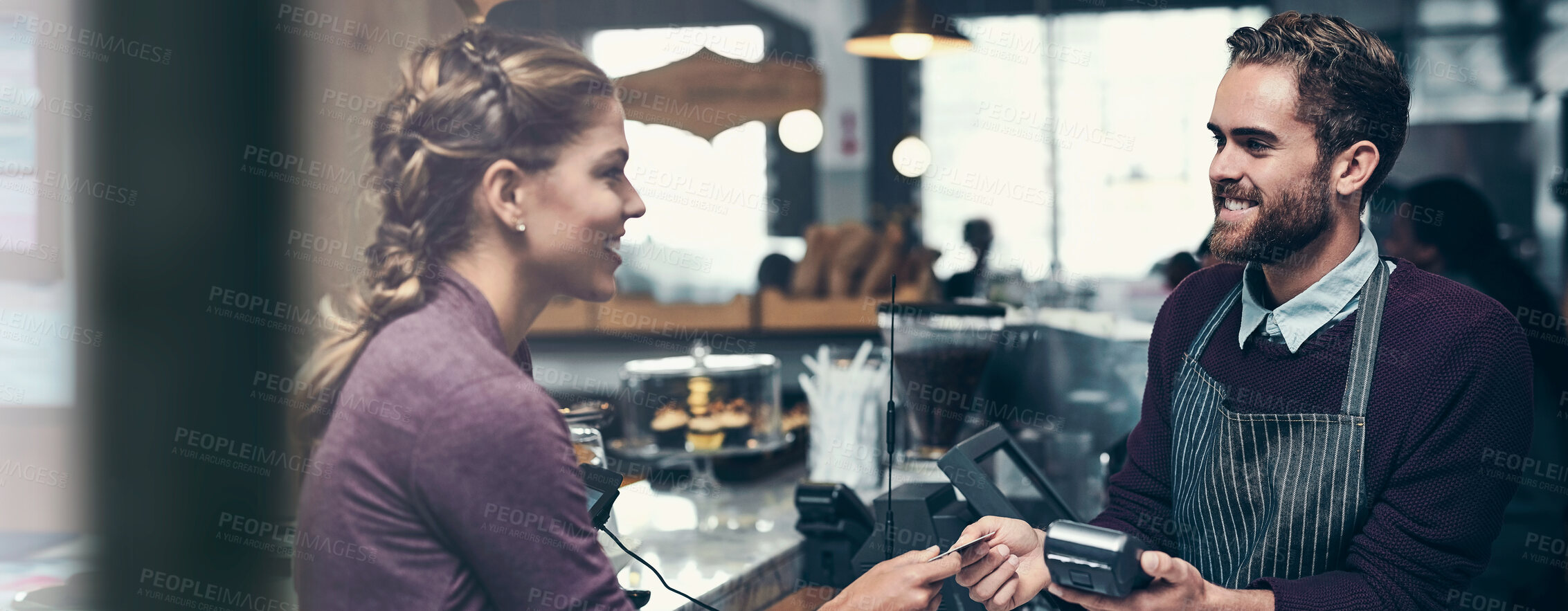 Buy stock photo Shot of a customer making a credit card payment at a cafe