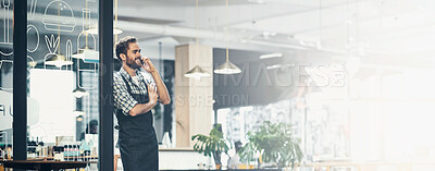 Buy stock photo Shot of a young man using a phone in the store that he works at