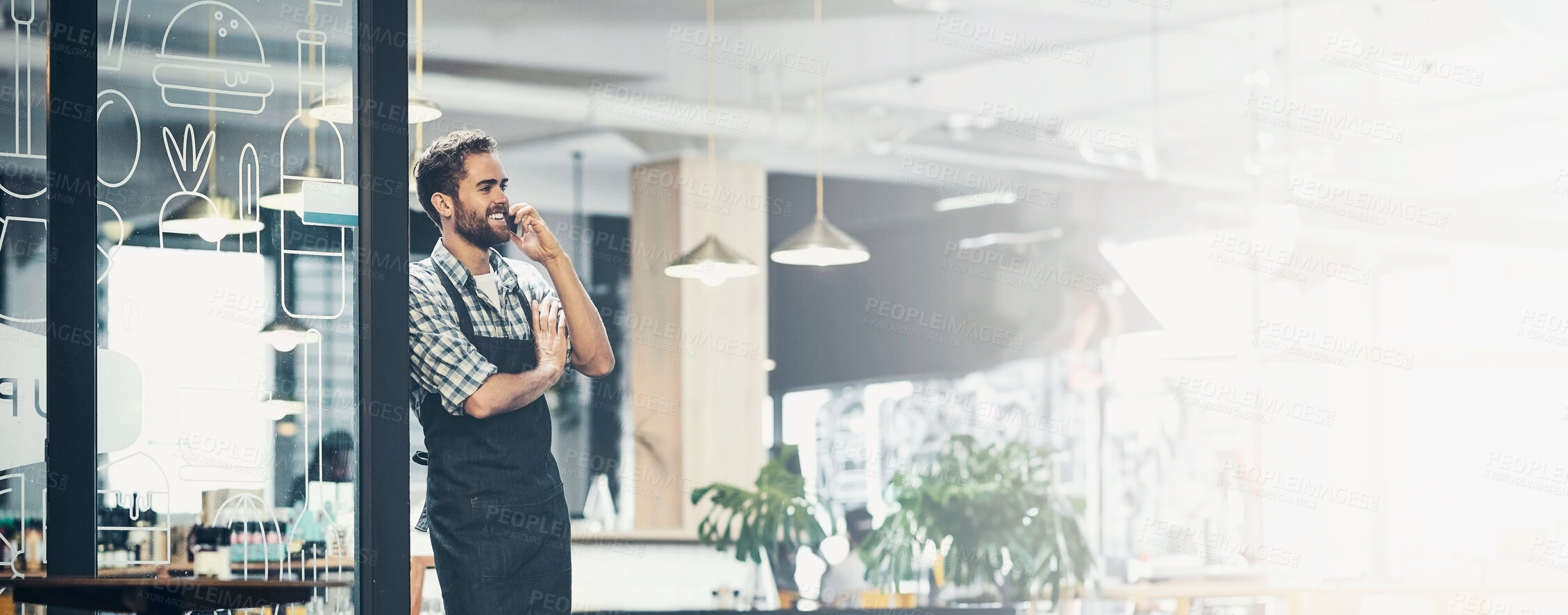 Buy stock photo Shot of a young man using a phone in the store that he works at