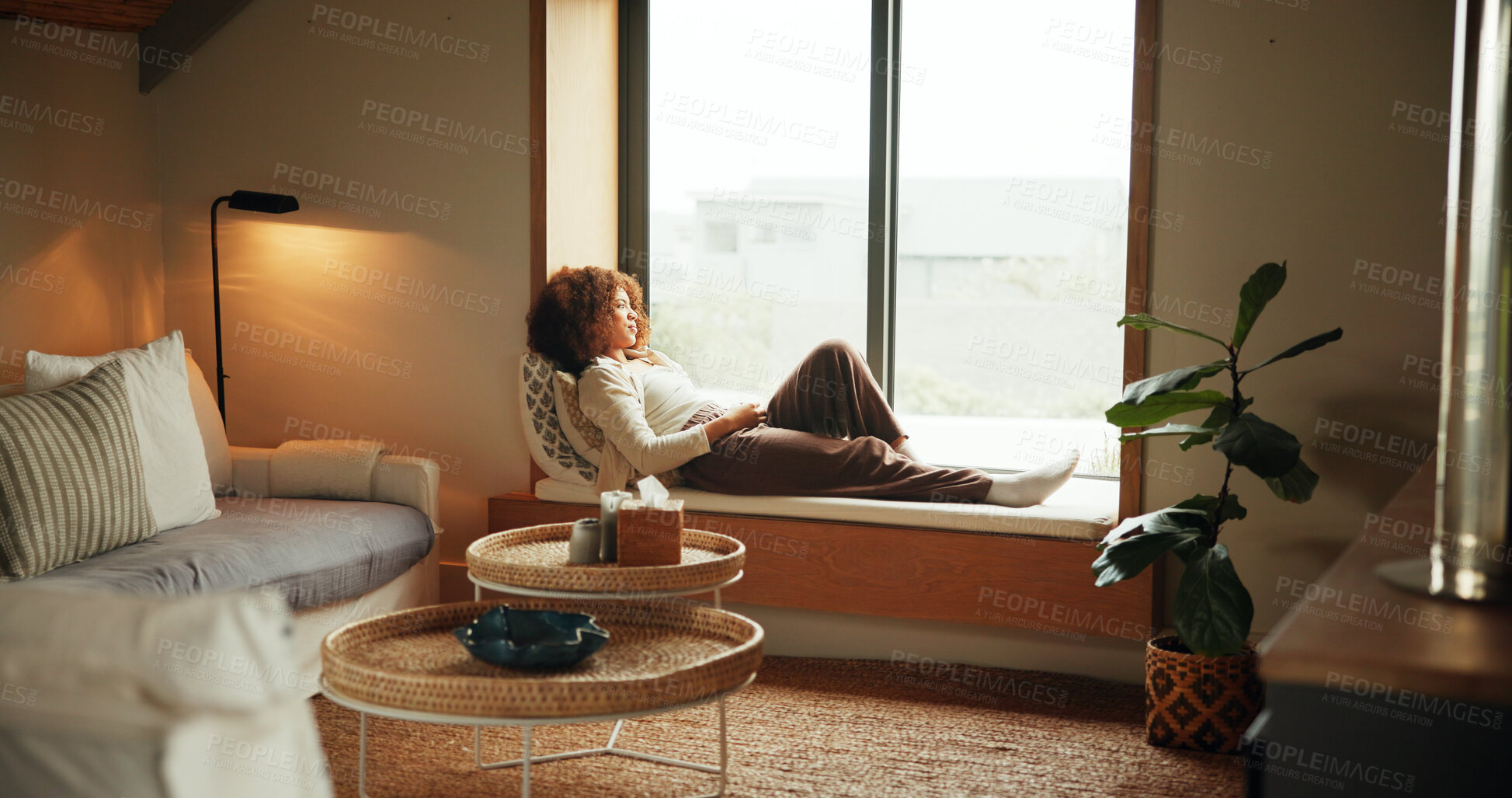 Buy stock photo African woman, thinking and relax by window for comfort, peace and planning on weekend with leisure. Female person, calm and chilling in home for lazy day, break and cozy in apartment with vision