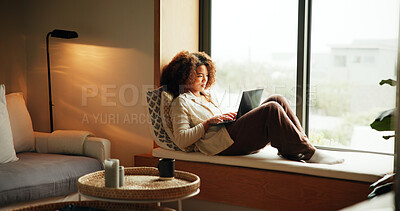 Buy stock photo Woman, laptop and relax by window for reading, calm and social media on weekend with website. Female person, subscription and comfort in home for lazy day, break and streaming in apartment with movie