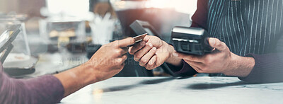 Buy stock photo Shot of a customer making a credit card payment at a cafe