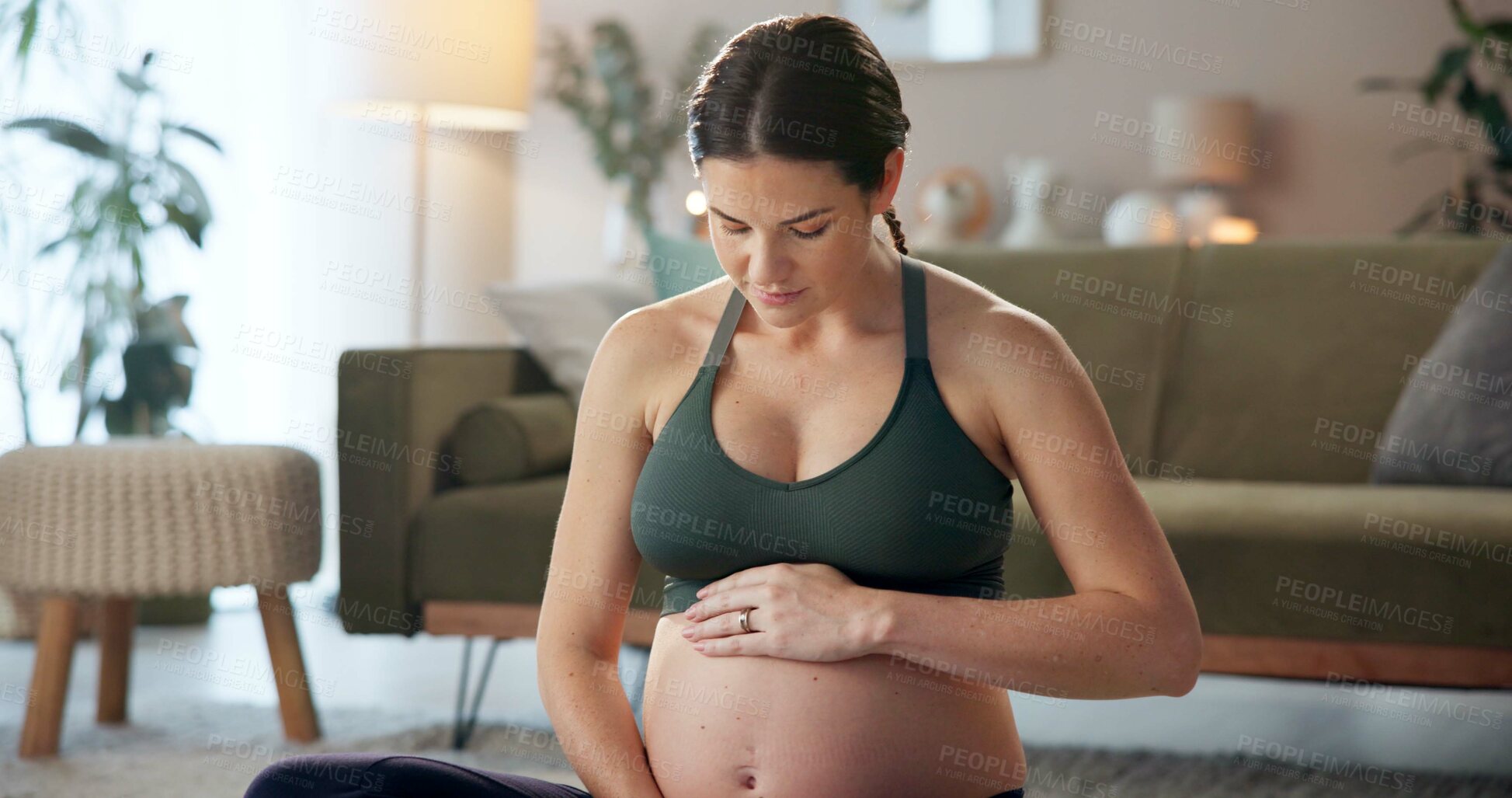 Buy stock photo Pregnant woman, exercise and stomach on floor in home with thinking, care and wellness in living room. Person, mother and reflection with touch, love and prenatal growth for belly in lounge at house