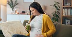 Pregnant woman, touch and thinking with green smoothie for nutrition, digestive health and wellness on sofa. Future mother, stomach and person with juice for diet vitamins or immune system boost