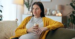 Coffee, relax and thinking with pregnant woman, couch and living room of home for maternity leave wellness. Break, warm drink and future mother with glass, apartment and comfort for pregnancy or rest