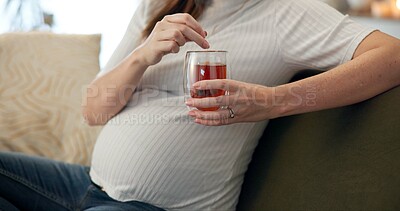Buy stock photo Herbal tea, relax and hands with pregnant woman, sofa and living room of home for maternity leave wellness. Break, warm drink and mother with detox glass, apartment and comfort for pregnancy or rest