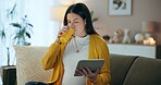 Detox, fruit juice and tablet for pregnant woman with sofa, living room and home for prenatal health. Belly, drink and thinking with mother, baby and apartment for future maternal wellness research