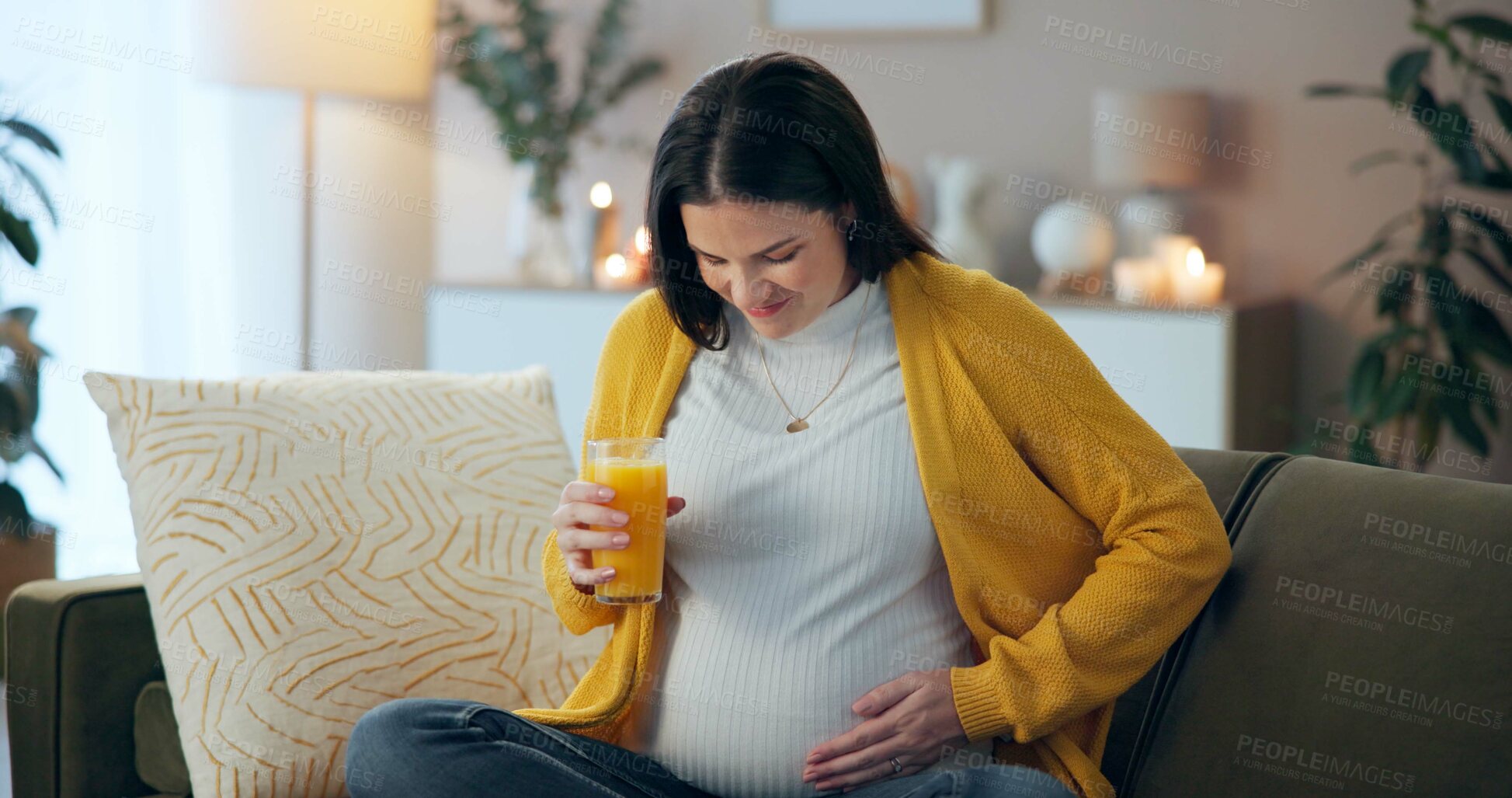 Buy stock photo Stomach pain, cramps and orange juice with pregnant woman on sofa for labor, emergency and sick. Pregnancy, anxiety and maternity with person in living room at home for baby, worry and frustrated