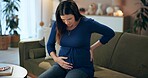 Home, pregnant woman and back pain on couch with anxiety, inflammation and joint tension from pregnancy. Living room, care and spine problem from muscle injury with worry and stress from labor