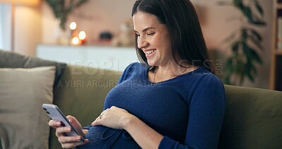 Buy stock photo Home, pregnant woman and smartphone with smile for social media, reaction and notification on sofa. Couch, future mother and happy with mobile app for pregnancy post, relax and online interaction