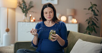 Buy stock photo Home, pregnant woman and jar with pickle for eating, nutrition and wellness for baby development. Sofa, female person and hungry with vegetable for pregnancy, craving and healthy snack for vitamin k
