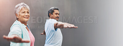 Buy stock photo Shot of a happy older couple practicing yoga together outdoors against a gray background