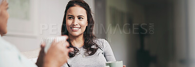 Buy stock photo Shot of a young woman and her mother catching up on the sofa while drinking coffee