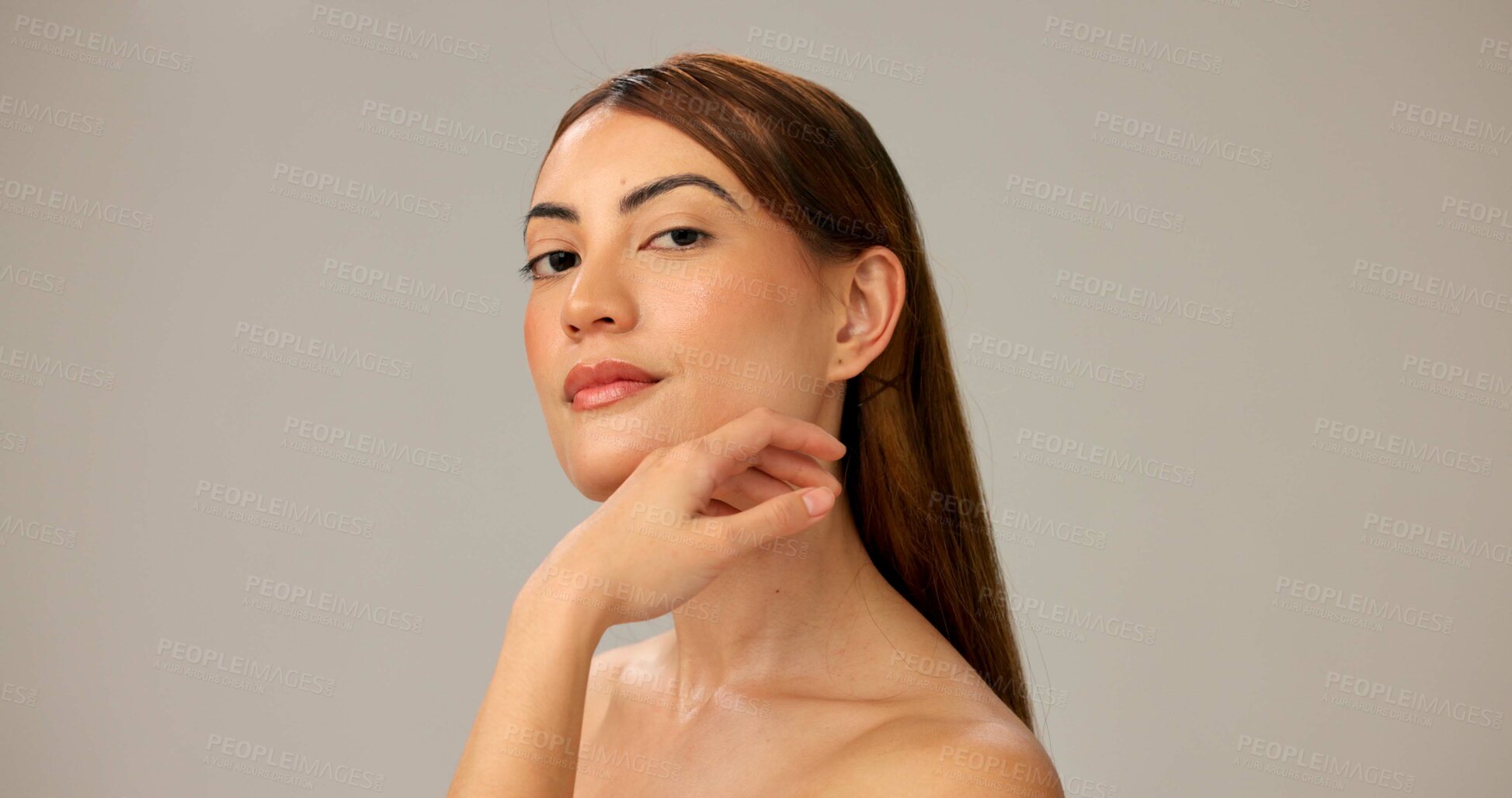 Buy stock photo Skincare, natural beauty and portrait of confident woman with glow, dermatology and shine. Face, touch and model with makeup, cosmetics or spa facial treatment for aesthetic on gray studio background