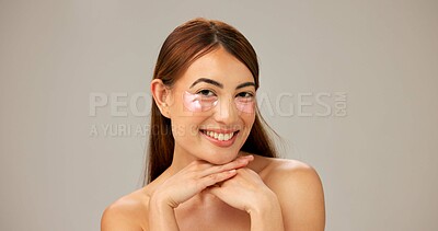 Buy stock photo Portrait, smile and woman with eye patches, dermatology and healthy skin on gray studio background. Happy person, model or girl with aesthetic, cosmetics or shine with cotton pads or grooming routine