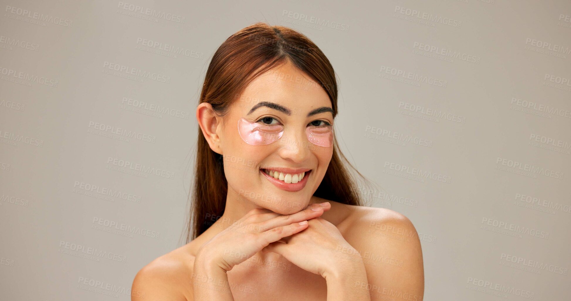 Buy stock photo Portrait, smile and woman with eye patches, dermatology and healthy skin on gray studio background. Happy person, model or girl with aesthetic, cosmetics or shine with cotton pads or grooming routine