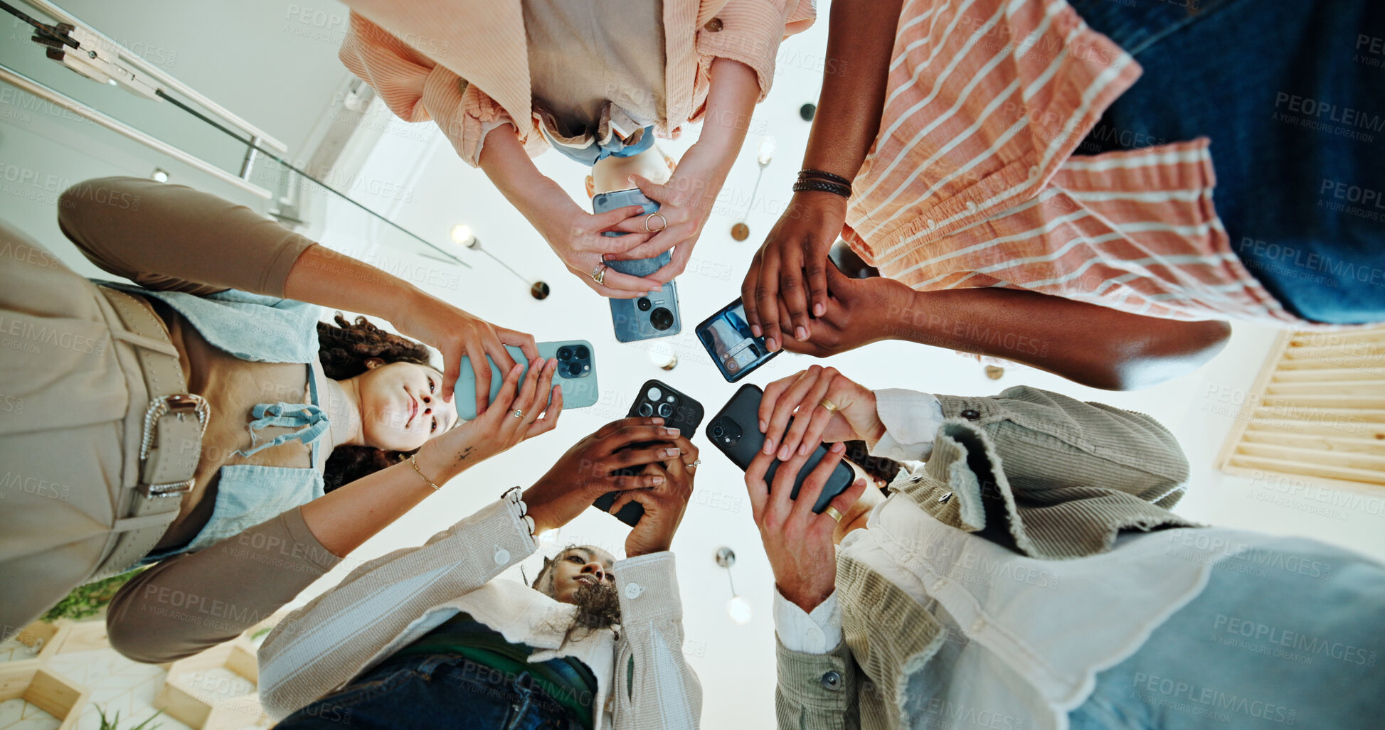 Buy stock photo People, circle and phones for university learning, online and teamwork in education on campus. Students, low angle and huddle for project solidarity in college, collaboration and united studying