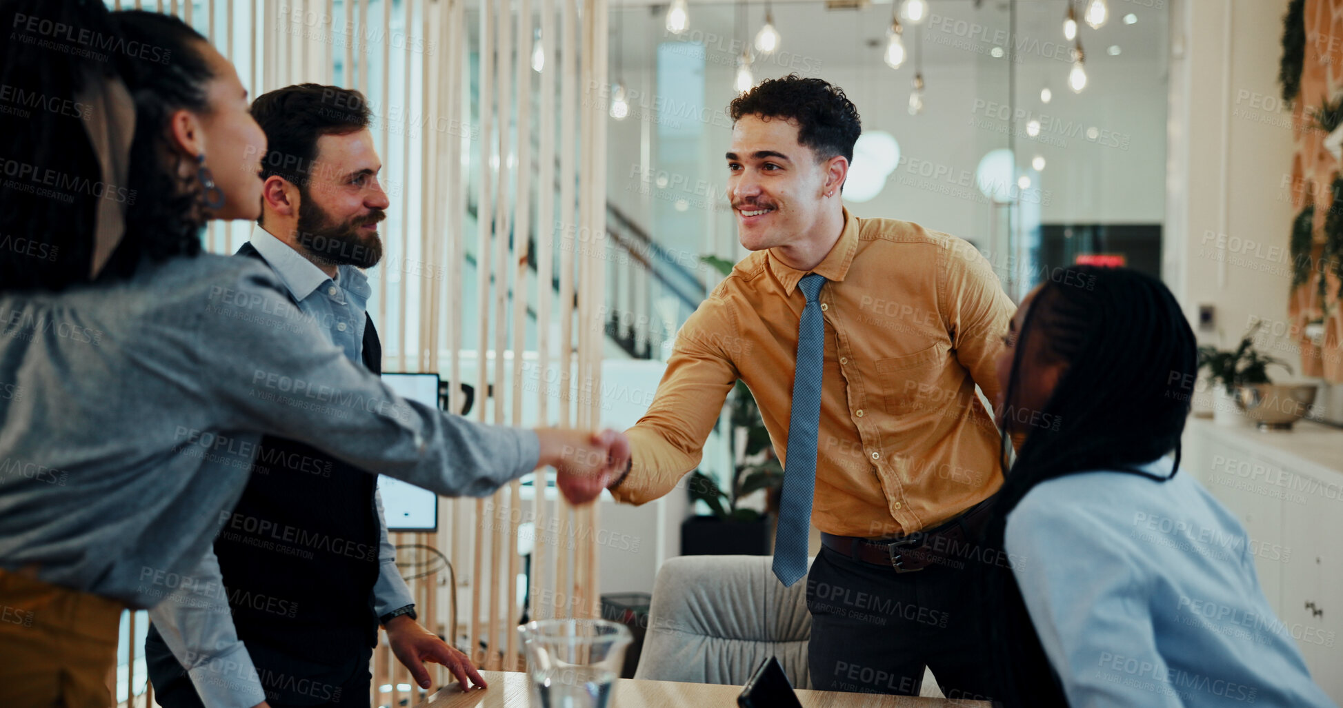 Buy stock photo Business man, woman and handshake at meeting with team for welcome, smile and collaboration at media company. People, group and shaking hands with b2b agreement, deal and happy at creative agency