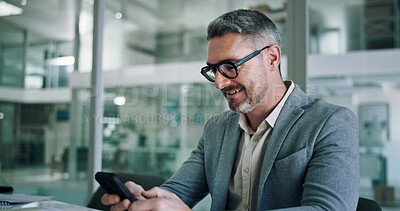 Buy stock photo Mature, business man and happy with phone in office for communication, text message or positive feedback on email. Professional, CEO and smile with smartphone for notification and reading good news