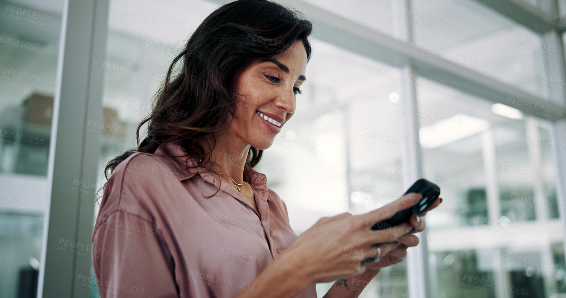 Buy stock photo Mature, business woman and happy with smartphone in office for communication, text message or positive feedback on email. Professional, person and smile with phone for notification, chat or good news