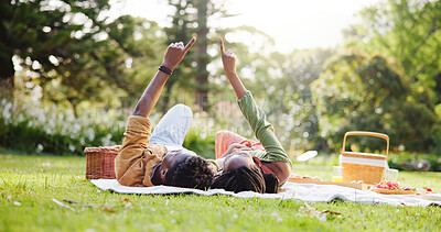Buy stock photo Pointing, picnic and black couple in nature relax on blanket for bonding, relationship and trust outdoors. Dating, park and man and woman look at sky for romance, anniversary celebration and weekend