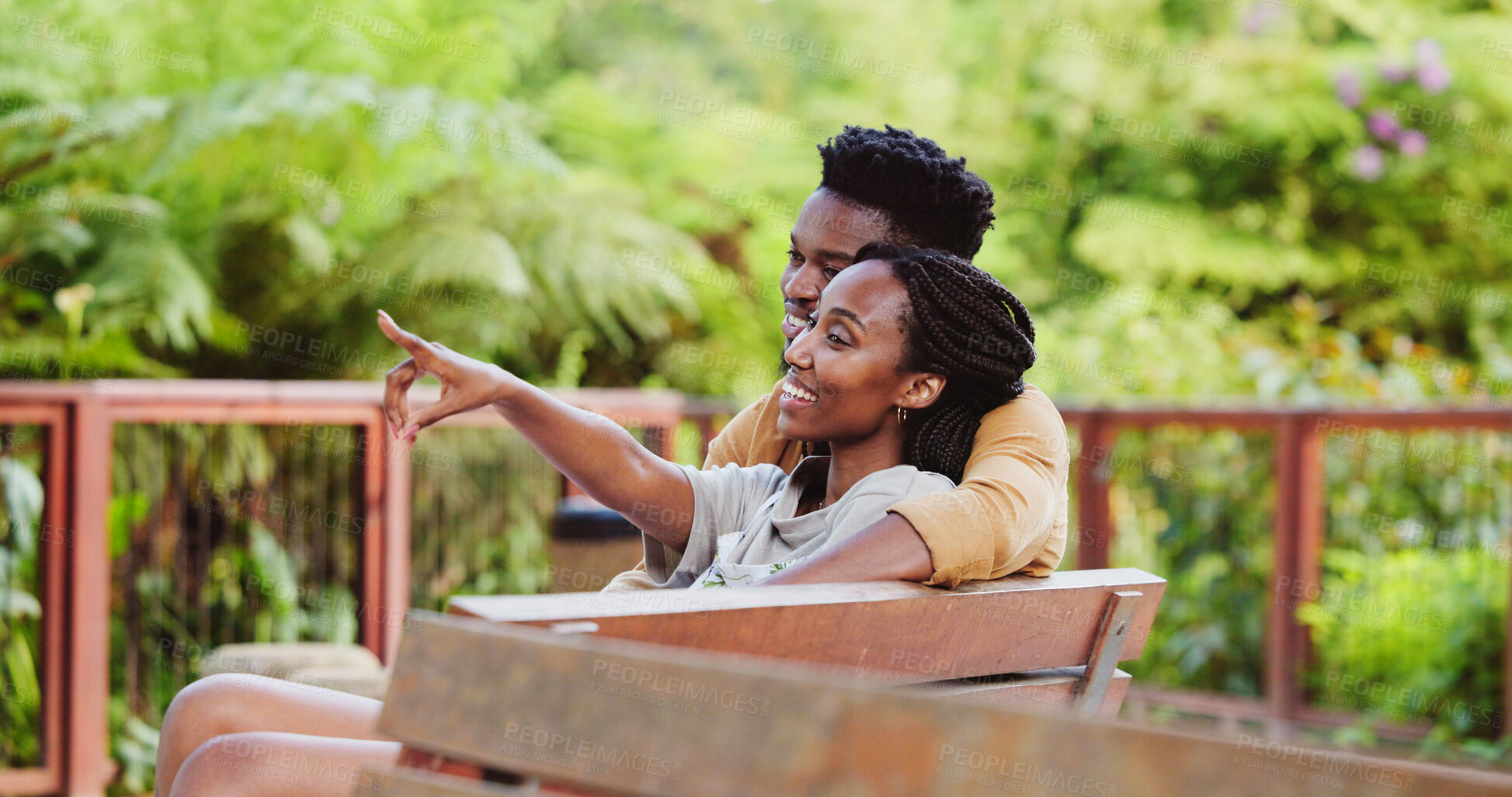 Buy stock photo Bench, pointing and black couple at park with smile, view and holiday in spring with date and love. Care, support and happy people in urban garden with bonding, bird watching and vacation together