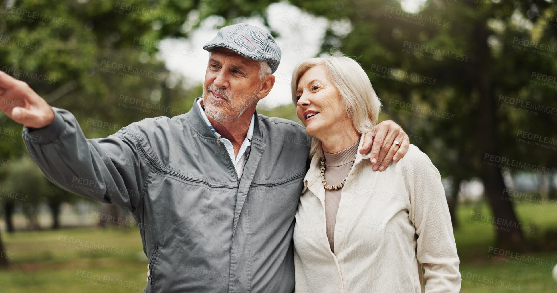 Buy stock photo Park, senior couple and happy with pointing on walk routine for retirement, support and bonding in Germany. People, relationship and smile with hugging outdoor for break, care and love as pensioner