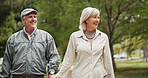 Smile, love and holding hands with old couple in park for retirement, happiness and wellness. Support, date and romance with senior man and woman walking for partner, marriage and peace together
