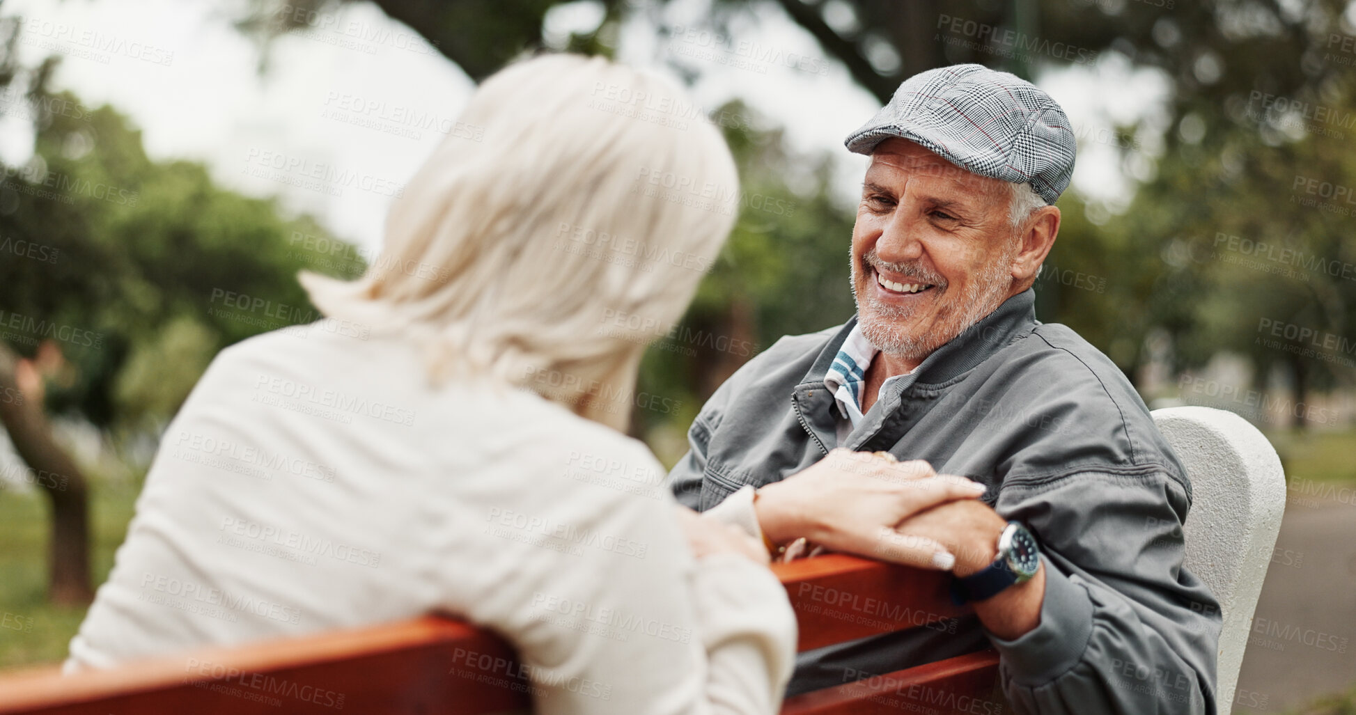 Buy stock photo Mature couple, talking and smile in park for bonding, conversation and commitment together outdoors. Retirement, marriage and elderly man and women in nature on bench for love, care and connection