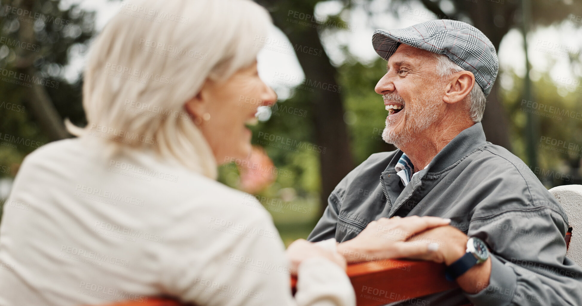 Buy stock photo Senior couple, laughing and smile in park for bonding, conversation and funny joke together outdoors. Retirement, marriage and mature man and women in nature on bench for love, care and connection