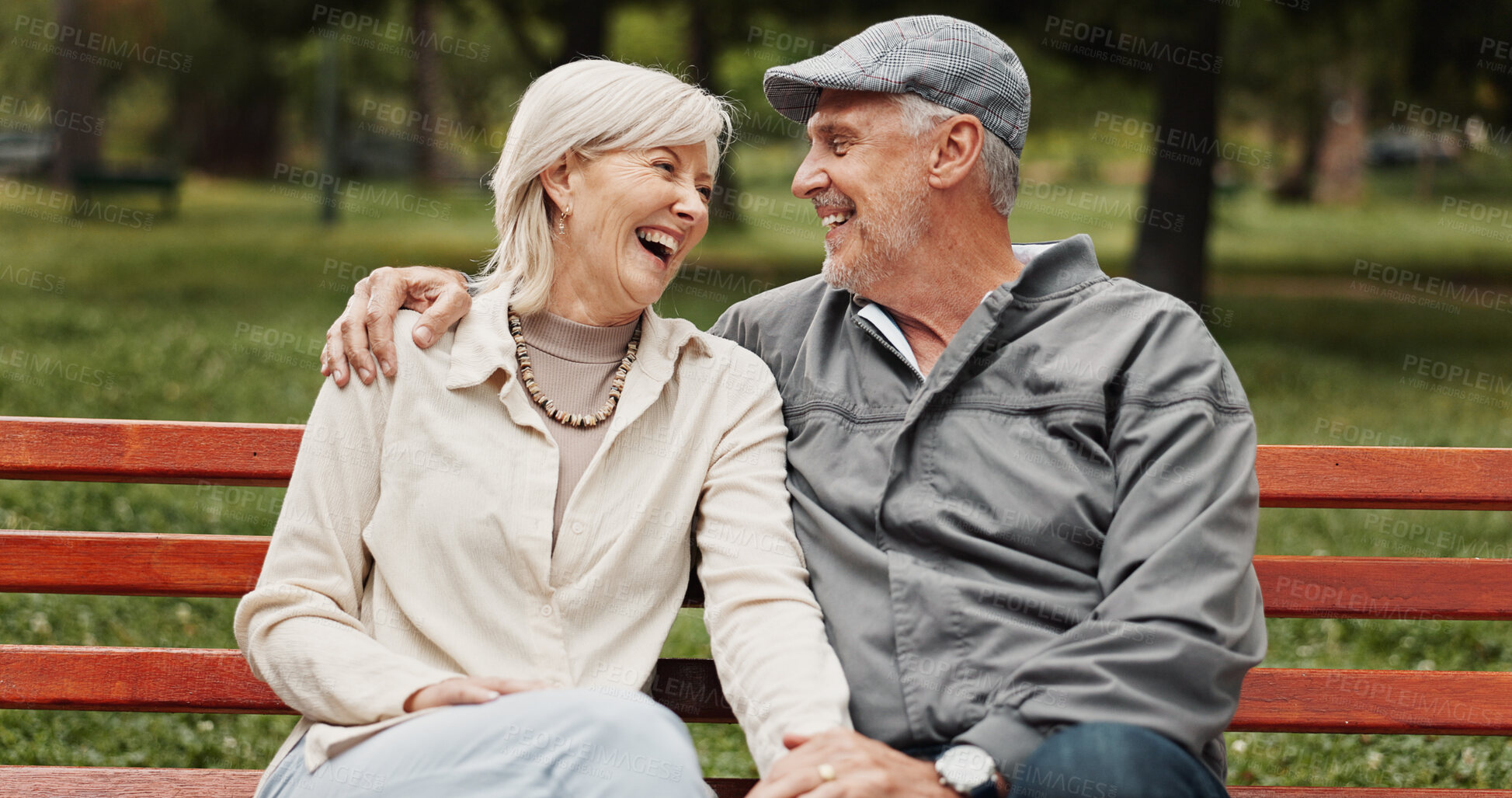 Buy stock photo Senior couple, hug and laughing in park for bonding, conversation and commitment together outdoors. Retirement, marriage and mature man and women in nature on bench for love, care and connection