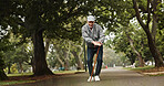 Elderly man, walking stick and dance in park with energy, happiness and excited for good news. Senior person with disability, cane and movement on nature path for retirement freedom with announcement