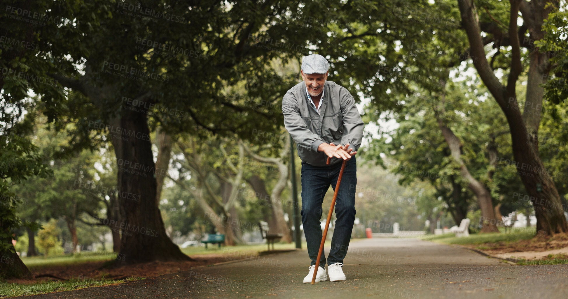 Buy stock photo Elderly man, walking stick and dance in park with energy, happiness and excited for good news. Senior person with disability, cane and movement on nature path for retirement freedom with announcement